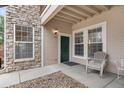 Inviting condo entrance with stone accents, covered entry and a cozy seating area at 3995 S Dillon Way # 102, Aurora, CO 80014