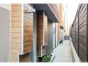 Private walkway leads to a modern townhome with wood siding at 3619 Navajo St, Denver, CO 80211