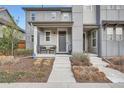 Inviting front porch with seating and modern landscaping at 8157 E 53Rd Dr, Denver, CO 80238