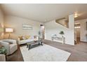 Bright living room with neutral decor, a plush rug, and stylish furnishings at 443 Hermosa St, Brighton, CO 80603
