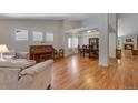 Spacious living room with hardwood floors, ample natural light, and open floor plan at 3563 Watada Dr, Brighton, CO 80601