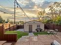 Charming backyard featuring a shed, patio, BBQ, and a well-maintained lawn with a wooden fence at 3401 N Steele St, Denver, CO 80205
