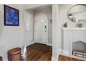 Welcoming entryway featuring hardwood floors, arched doorway, and decorative fireplace mantel at 3401 N Steele St, Denver, CO 80205