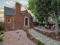 Charming brick home with a stone walkway leading to the front door and a cozy outdoor seating area at 3401 N Steele St, Denver, CO 80205