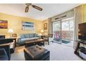 Cozy living room features a sliding glass door to a screened patio and bright, natural light at 3164 S Wheeling Way # 302, Aurora, CO 80014