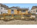 Charming home features a modern fence, a well-maintained lawn, and tasteful exterior color scheme at 3440 Chase St, Wheat Ridge, CO 80212