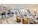Bright and airy living room seamlessly blends into the open-concept kitchen and dining area at 3440 Chase St, Wheat Ridge, CO 80212