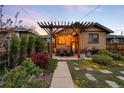 Outdoor dining area boasts a beautiful pergola and well-manicured landscaping at 1918 S Lincoln St, Denver, CO 80210