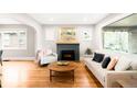 Inviting living room features a cozy fireplace, hardwood floors, and plentiful natural light at 1918 S Lincoln St, Denver, CO 80210