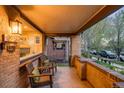 Covered front porch with brick accents, seating area, and an inviting entryway at 1918 S Lincoln St, Denver, CO 80210