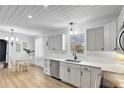 Bright kitchen with white cabinets, stainless steel appliances, and a cozy dining area at 6707 S Elizabeth St, Centennial, CO 80122