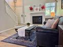 Cozy living room with modern fireplace, contemporary decor, and wood-look flooring at 6895 W 84Th Way # 4, Arvada, CO 80003