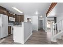 Modern kitchen with white cabinets, wood accents, and an island at 257 Wadsworth Cir, Longmont, CO 80504