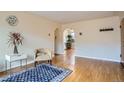 Bright living room with hardwood floors, calming neutral walls, and arched doorways at 1523 Ivy St # 6, Denver, CO 80220