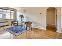 Charming living room featuring hardwood floors, neutral walls, large window, and comfortable seating at 1523 Ivy St # 6, Denver, CO 80220
