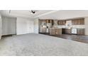 This spacious living room features carpeted floors and opens up to the kitchen and dining area at 449 Dunmire St, Frederick, CO 80530