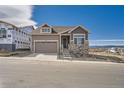Beautiful two-story home with stylish stone accents, an attached garage, and a welcoming entrance at 483 Basin Daisy St, Castle Rock, CO 80104