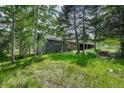 Landscaped exterior view of a home surrounded by lush trees and greenery at 25694 Stansbery St, Conifer, CO 80433