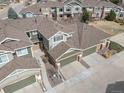 Aerial view of townhomes featuring well-maintained landscaping and private garages at 15063 E Crestridge Dr, Centennial, CO 80015