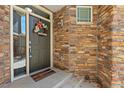 Inviting entryway featuring a decorative wreath and colorful stone accents at 15063 E Crestridge Dr, Centennial, CO 80015