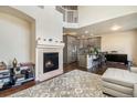 Open concept living room with fireplace, hardwood floors, and stainless steel appliances at 15063 E Crestridge Dr, Centennial, CO 80015