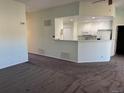 Open living area flows into the kitchen area with white cabinets, creating a functional and inviting space at 7777 S Biloxi Way, Aurora, CO 80016