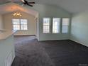 Bright living room with vaulted ceilings, a ceiling fan, and multiple windows that provide natural light at 7777 S Biloxi Way, Aurora, CO 80016