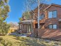 Attractive two-story townhome with wood siding, landscaping, and a walkway at 9485 W 81St Ave # B, Arvada, CO 80005