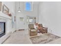 Bright living room with high ceilings, fireplace, and large windows offering natural light at 8943 Tappy Toorie Cir, Highlands Ranch, CO 80129