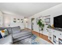 Cozy living room featuring hardwood floors and a stylish gray sectional sofa at 6436 S Kline St, Littleton, CO 80127