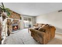 Cozy living room with stone fireplace and balcony at 18302 E Kepner Pl # 207, Aurora, CO 80017