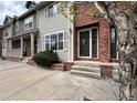 Close up of townhouse exterior with brick accents and well-manicured front yard at 438 N Parkside Dr # C, Longmont, CO 80501