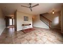 Spacious living room featuring tile floors, ceiling fan, and staircase access at 438 N Parkside Dr # C, Longmont, CO 80501