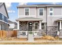 Charming two-story home with a welcoming porch and beautiful stone accents, enhancing its curb appeal at 21823 E 8Th Ave, Aurora, CO 80018