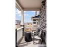 Cozy covered porch featuring comfortable seating and a fire pit for relaxing evenings at 21823 E 8Th Ave, Aurora, CO 80018