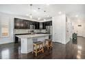 Open concept kitchen with stainless steel appliances, island with seating, and modern finishes at 6674 Fonder Villa Dr, Parker, CO 80134