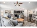 Open floor plan with hardwood floors, a ceiling fan, and an eat-in kitchen with a large island at 6674 Fonder Villa Dr, Parker, CO 80134