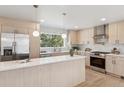 Well-lit kitchen with white countertops, stainless steel appliances, and ample cabinet space at 5467 W Hinsdale Pl, Littleton, CO 80128