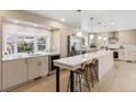 Bright and modern kitchen with an island, stainless steel appliances, and elegant pendant lighting at 5467 W Hinsdale Pl, Littleton, CO 80128