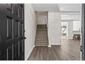 Interior entryway with black door and carpeted stairs leading upstairs at 1759 Quail St, Lakewood, CO 80215