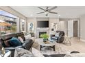 Inviting living room with a fireplace, comfortable leather seating, and ample natural light at 8035 S Kewaunee St, Aurora, CO 80016