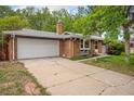 Charming single Gathering home featuring a brick exterior, attached garage and driveway with landscaped yard at 8269 Zephyr St, Arvada, CO 80005