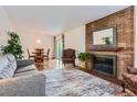 Inviting living room featuring a classic brick fireplace and ample seating, great for Gathering gatherings at 6748 S Gallup St, Littleton, CO 80120