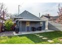 Back exterior showing outdoor entertaining space and backyard at 3052 S Cherokee St, Englewood, CO 80110