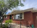 Exterior view of brick home with access ramp and well-manicured landscaping at 7127 Otis St, Arvada, CO 80003