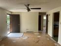 Spacious living room featuring a ceiling fan and a view of the kitchen area at 7127 Otis St, Arvada, CO 80003