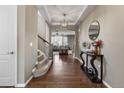 Inviting entryway with hardwood floors, elegant staircase, and decorative console table creating a warm welcome at 2669 Red Bird Trl, Castle Rock, CO 80108