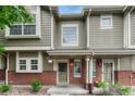 Charming townhome featuring a brick facade, covered porch, and well-maintained landscaping at 9110 Gale Blvd # 3, Thornton, CO 80260