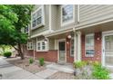 Charming two-story townhome with brick accents, inviting front porch, and manicured landscaping at 9110 Gale Blvd # 3, Thornton, CO 80260