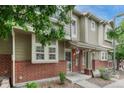 Charming two-story townhome with brick accents, inviting front porch, and manicured landscaping at 9110 Gale Blvd # 3, Thornton, CO 80260
